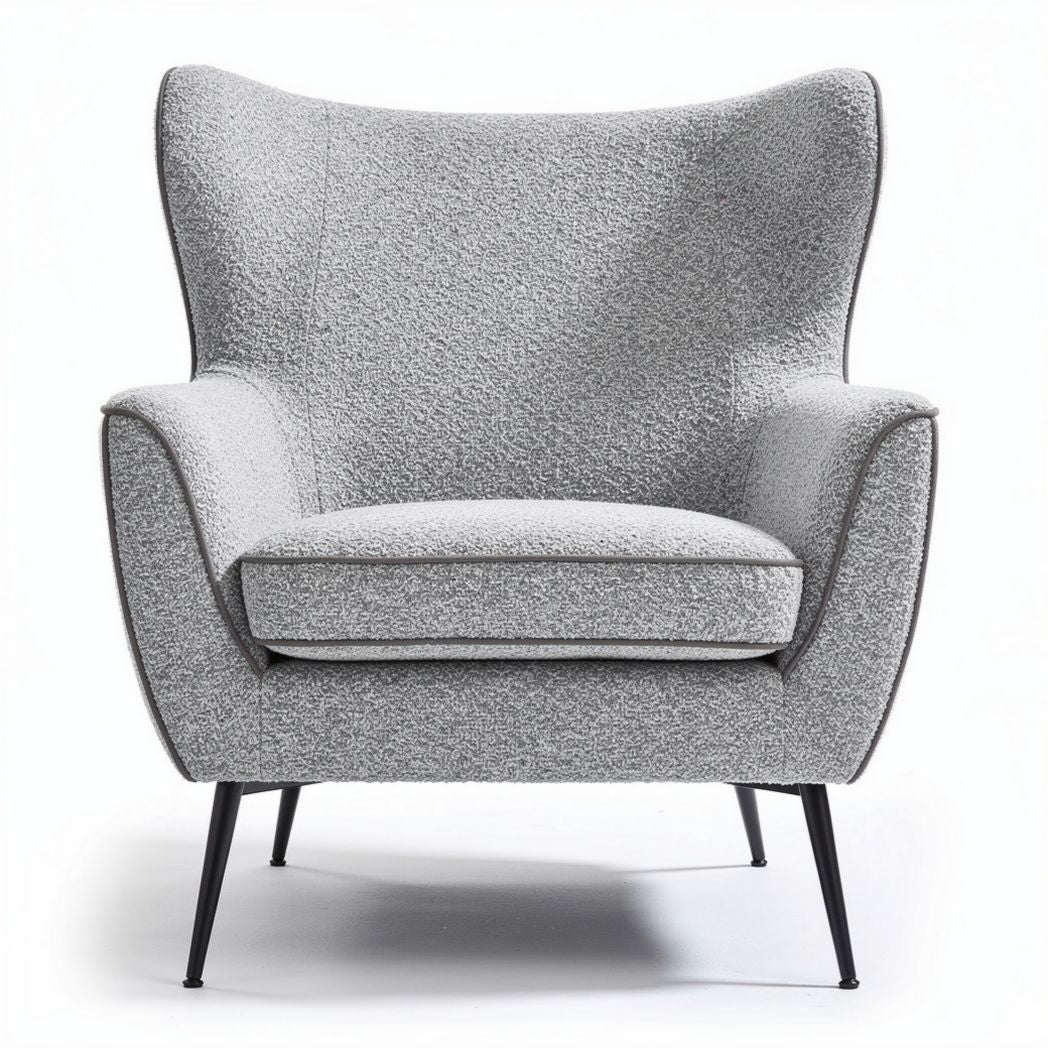 Grey upholstered accent chair with wingback design and metal legs